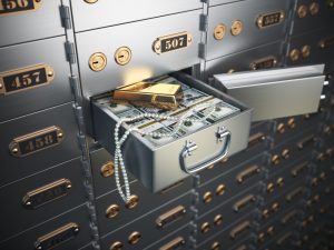 A safe deposit box with money, gold and jewelry in it.