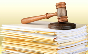 A gavel on a stack of files
